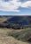 Rolling hills and a bright-blue sky with a lens flare.